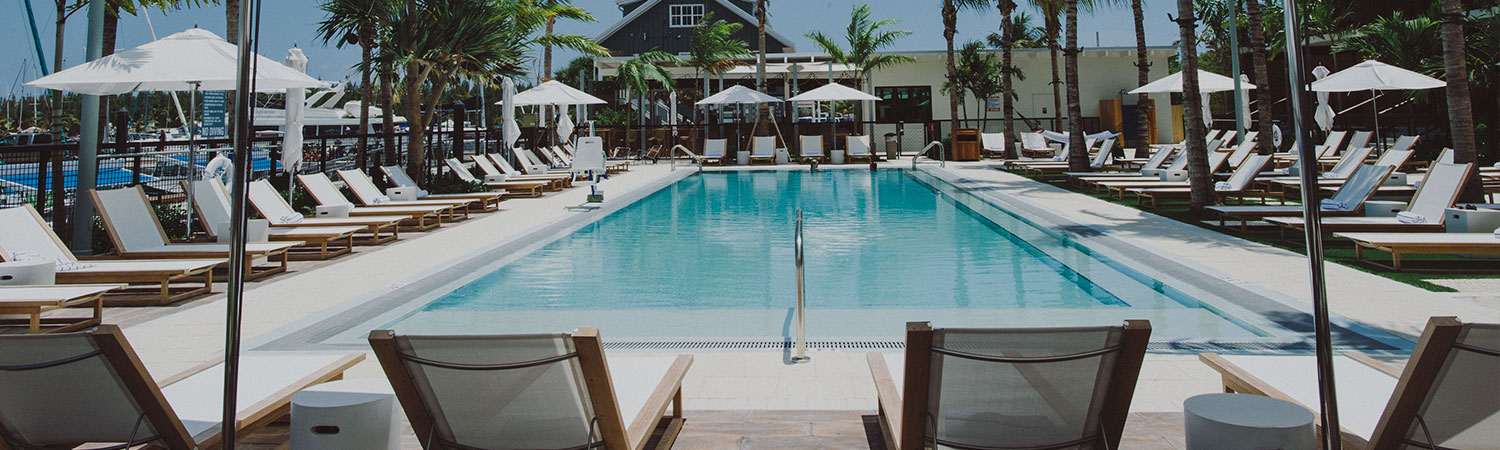 image of pool deck and sun chairs on a sunny day