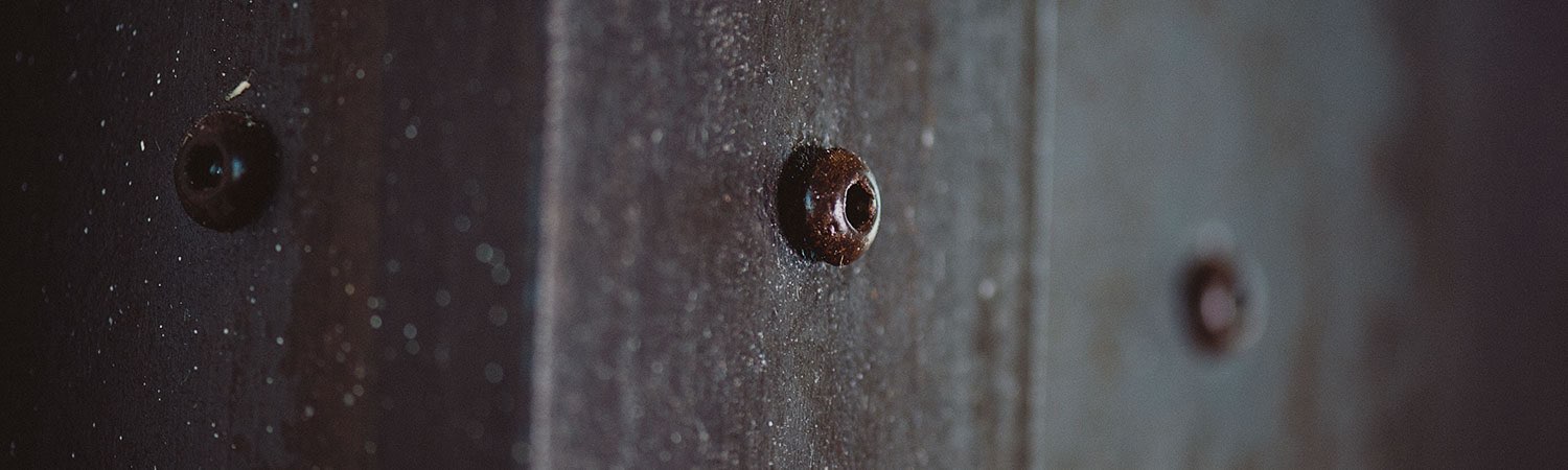 Close up of bronze nails on wall
