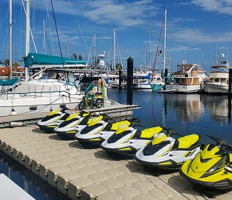 jet skis on dock with boats in the background