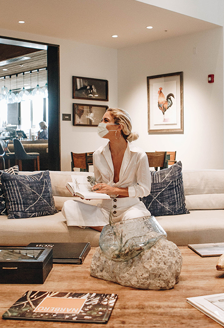 woman in hotel lobby wearing mask