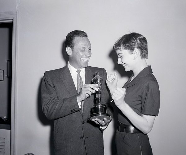 Old image of man handing woman award