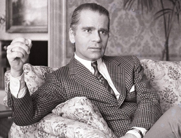 gentleman wearing a suit relaxing in armchair