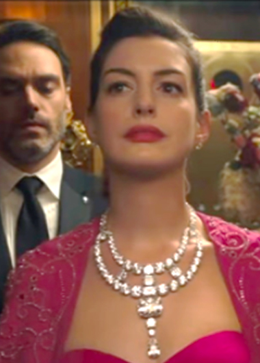 woman with red dress and large necklace