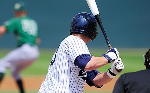 a baseball player about to hit the ball
