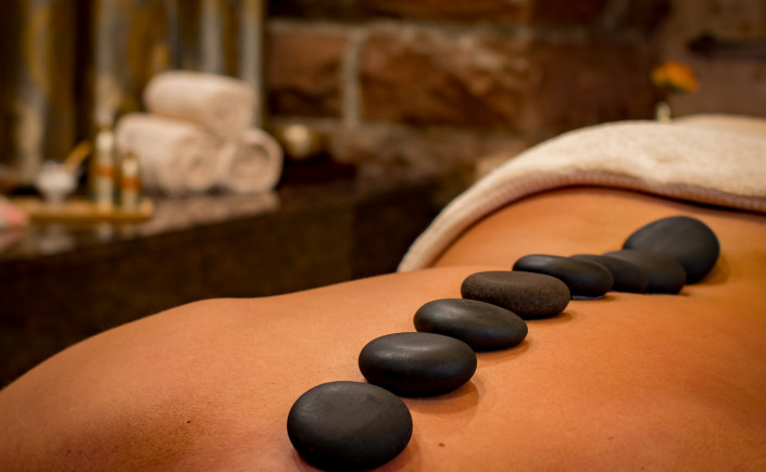 Back of person receiving hot stone massage