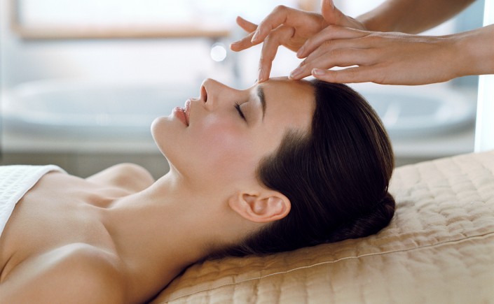 Woman receiving relaxing spa facial