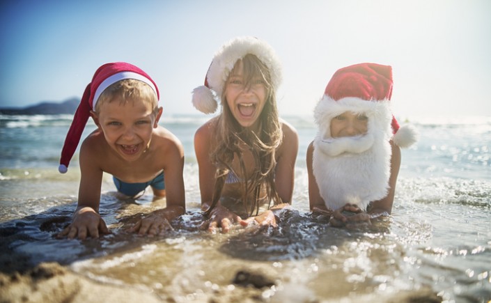 kids at the beach dressed as santa