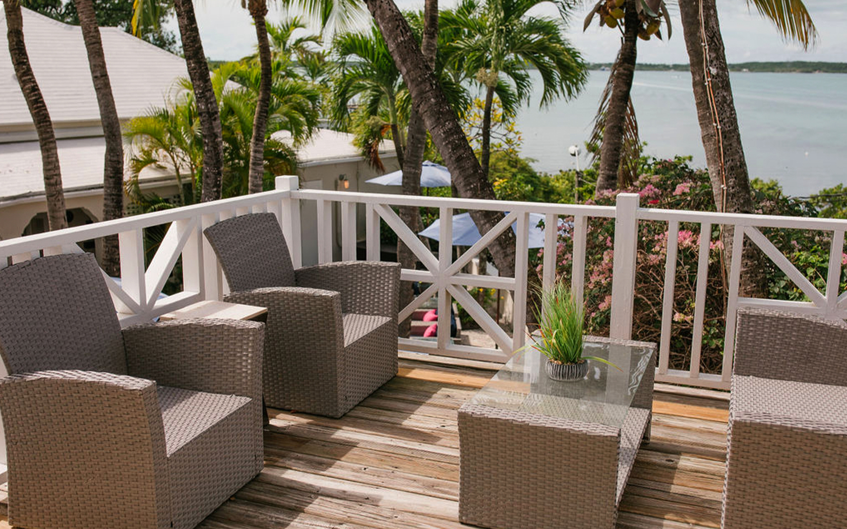 terrace with four outdoor chairs and ocean view