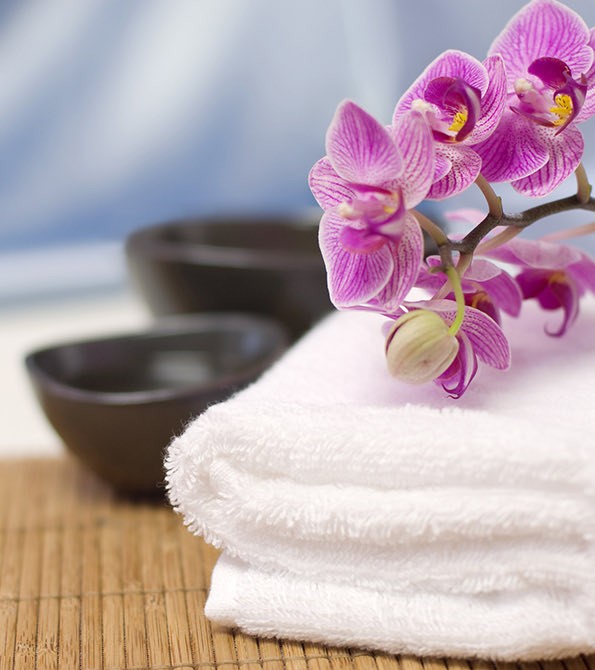 A spa towel with violet flowers on it