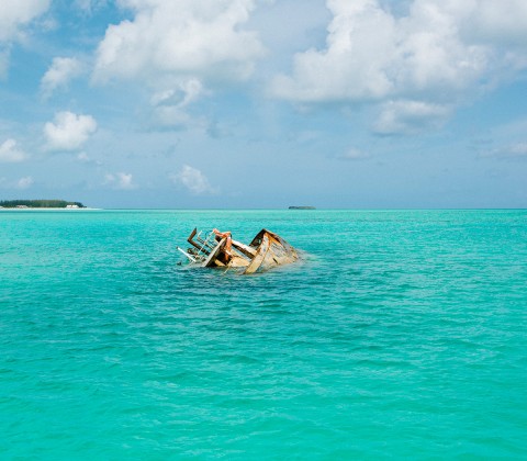 An old ship in the middle of the turquoise ocean
