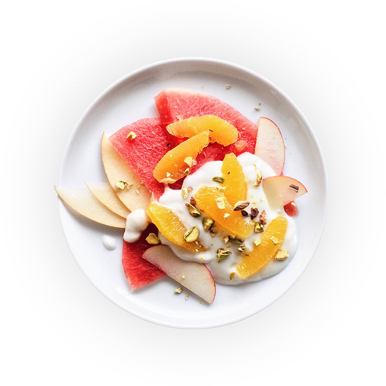 Top view of a dish full of tropical fruits and greek yogurt 