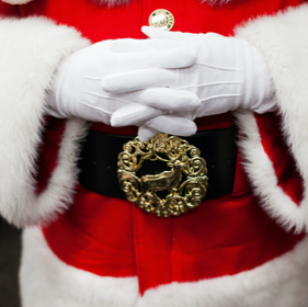 close up of santa's belt with his hands crossed on his belly