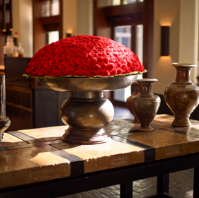 pot of red roses on a table in the lobby