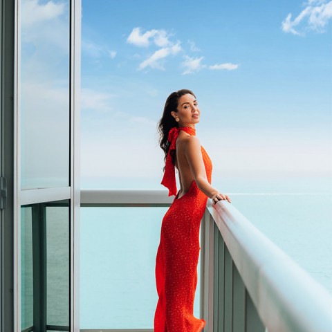 lady wearing red dress in a balcony