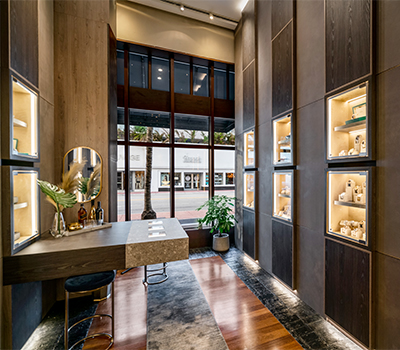 a room with dark wood walls and shelves with a variety of spa products