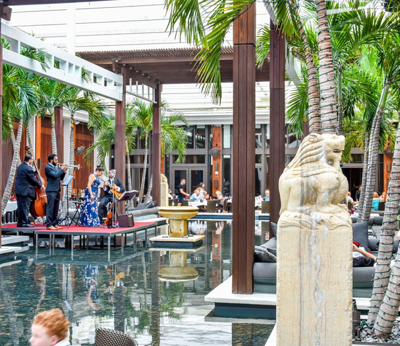 a band performing with their stage over the water