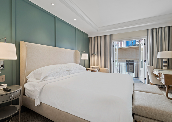 guest bedroom with a king bed and balcony