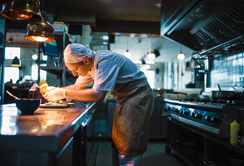 chef finishing plating food