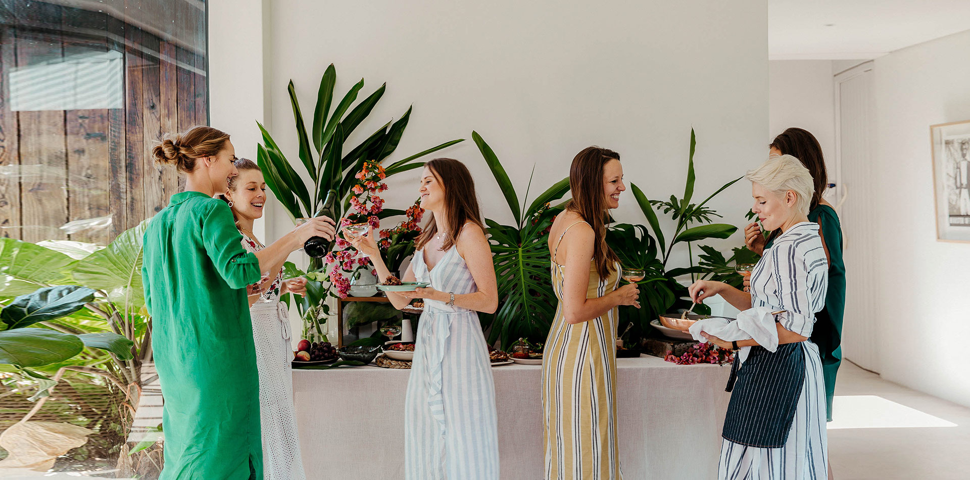 people enjoying food on plates while standing