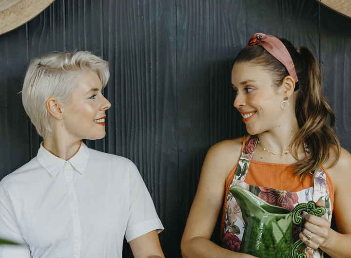 2 women smiling at each other