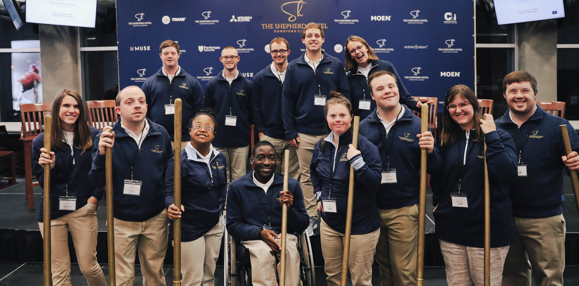 people smiling with shovels