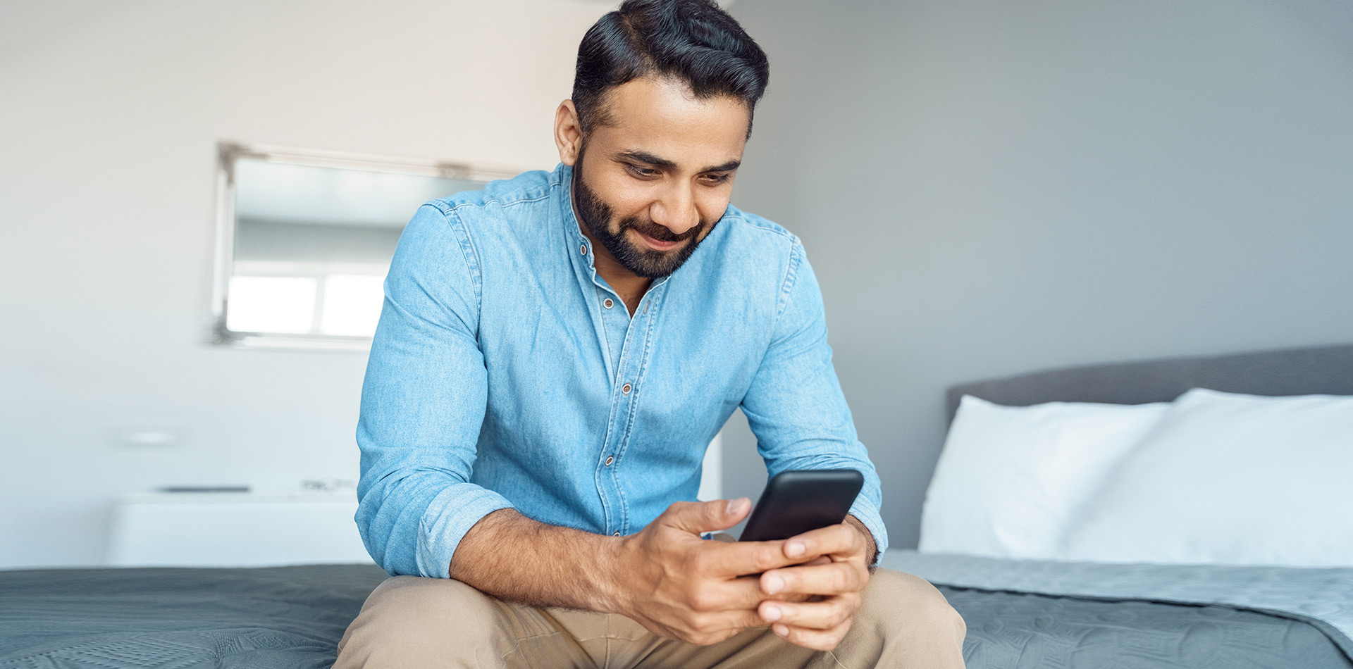 man smiling at phone