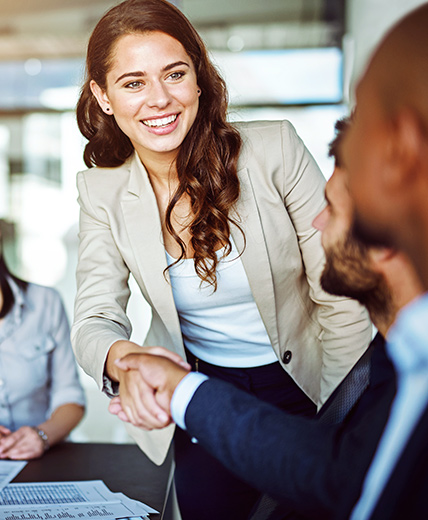 woman smiling shaking man's hand