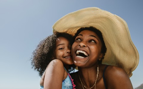 african american woman laughing with her daughter