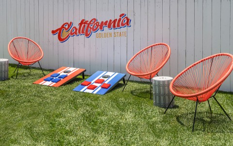 "California" ob fences with orange chairs and cornhole boards