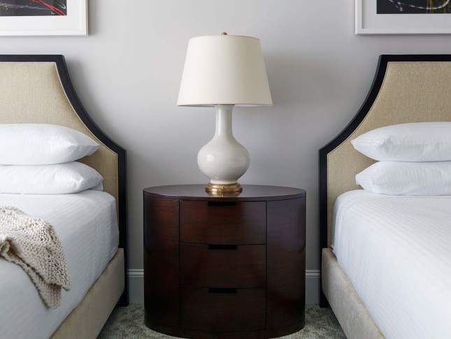 two headboards and a circle nightstand in between 