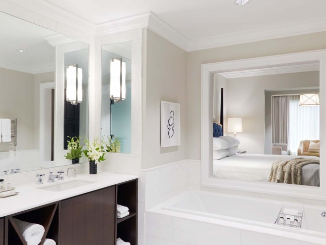 spacious private bathroom in a suite room of property in white accents