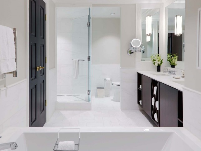 spacious and modish washroom of property in white accents