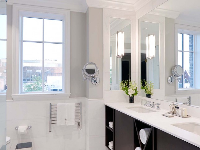 closeup view of spacious and modish washroom of property in white accents