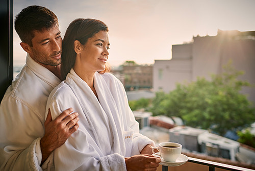 couple in robes on balcony
