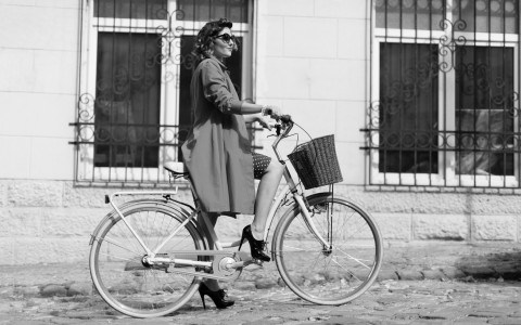 girl riding a bike with basket