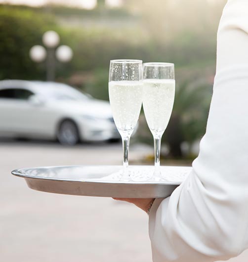 butler holding champagne on a tray