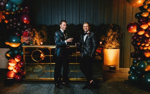 groom and groom posing in an indoor place decorated with flowers