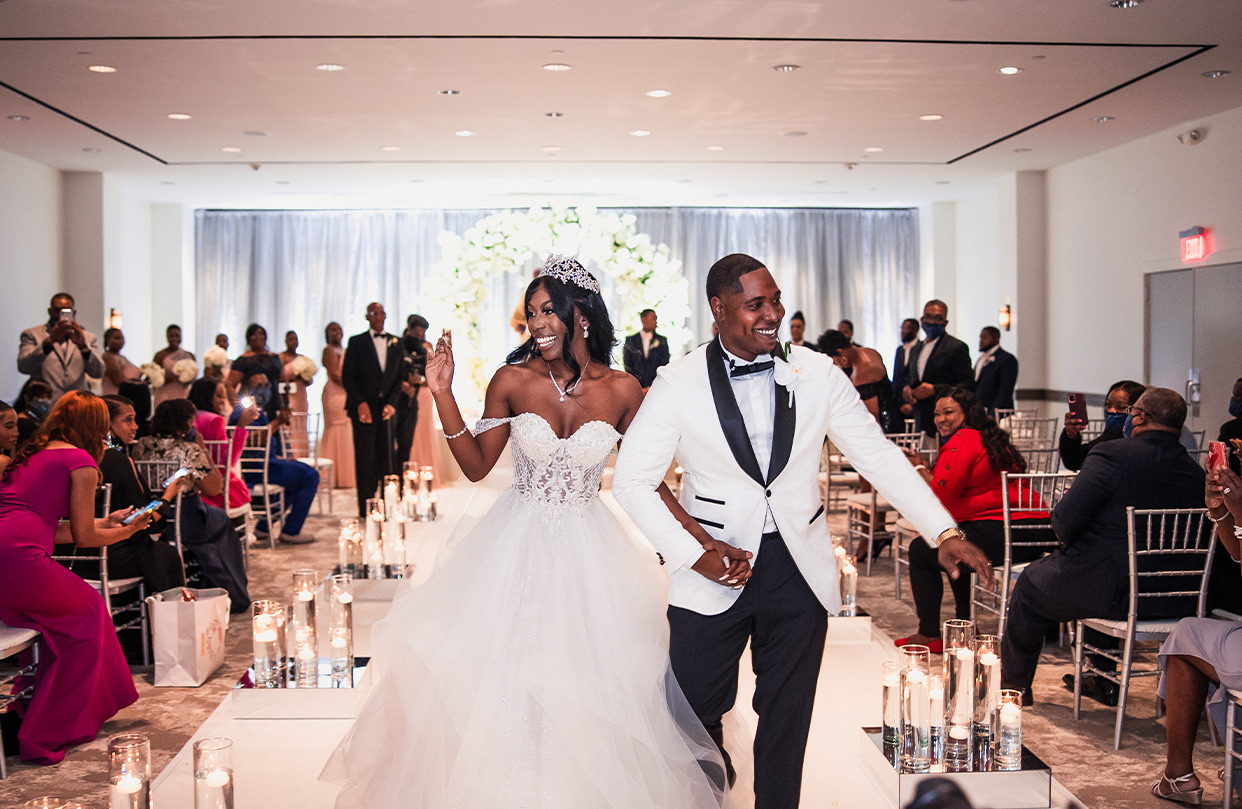 a just married couple walking to the exit of the room