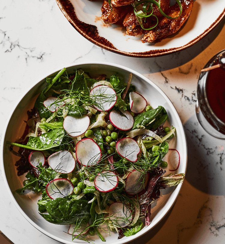 beautifully plated salad with thin slices of radishes
