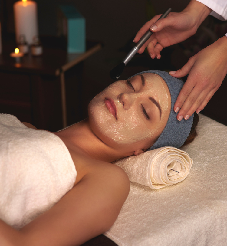 Woman laying down while getting a spa facial treatment
