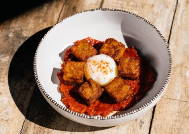 breakfast with red sauce and poached egg in a bowl