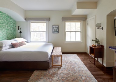 guestroom with carpet, bench and windows