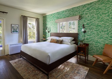 stavrand guestroom with bed and green pattern wall
