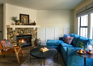 stavrand guestroom seating area with lit fireplace and coffee table
