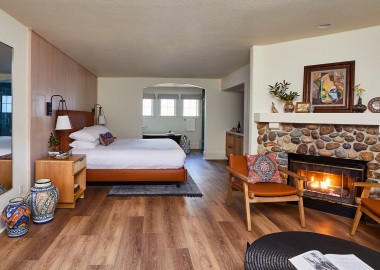 stavrand guestroom with bed, fire place and seating area