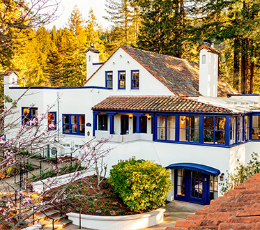 blue and white belden house from the outside and above