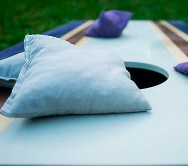 stavrand amenities blue conrnhole board and bags up close