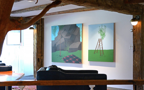 art on the walls with couch in front