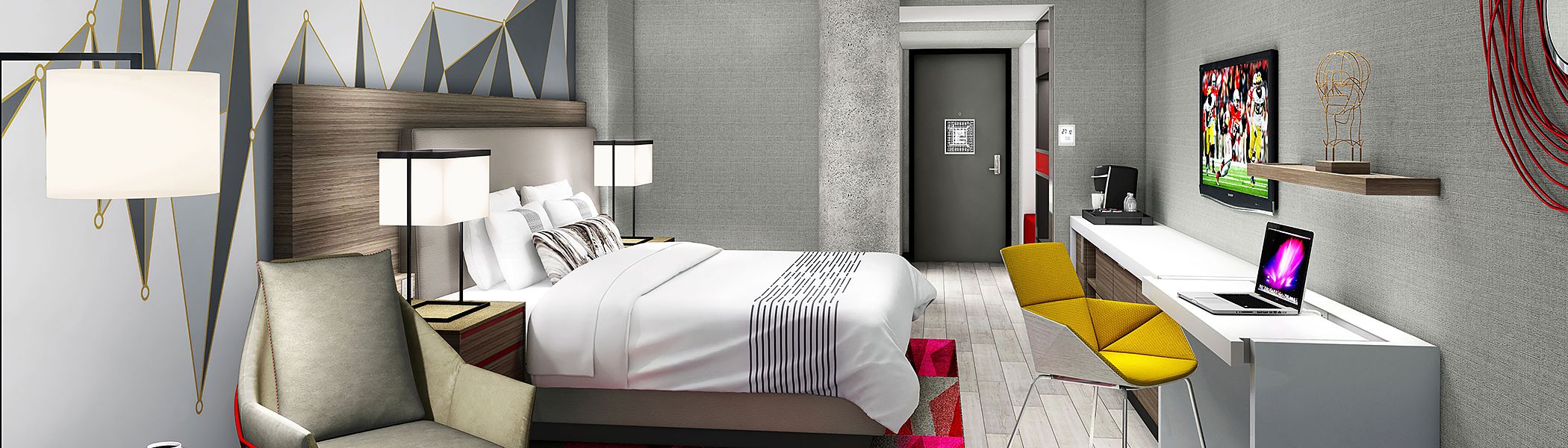 Room with king bed, white desk, yellow accent chair & modern wall art
