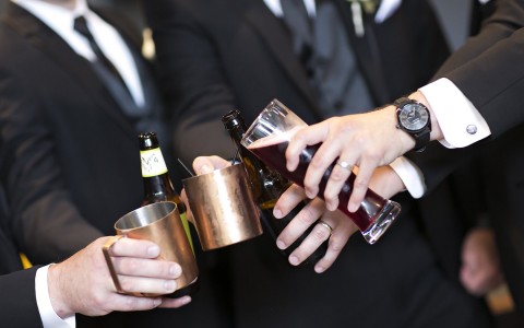Photo credit to Dan Kinzie, groomsmen toasting to a wedding